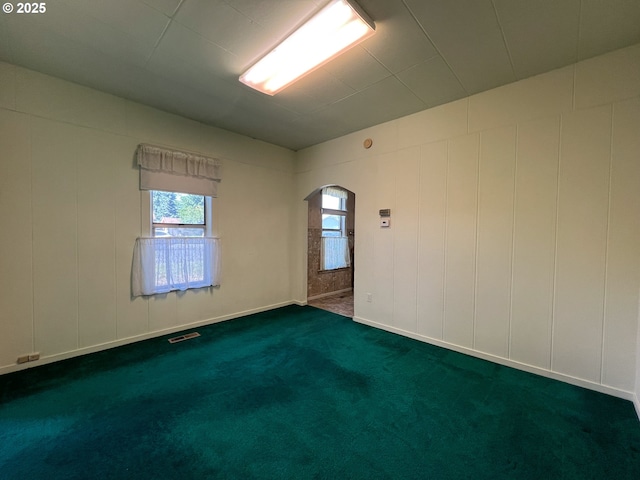 2909 College St, Baker City, OR 97814 - unfurnished room with arched walkways and dark colored carpet