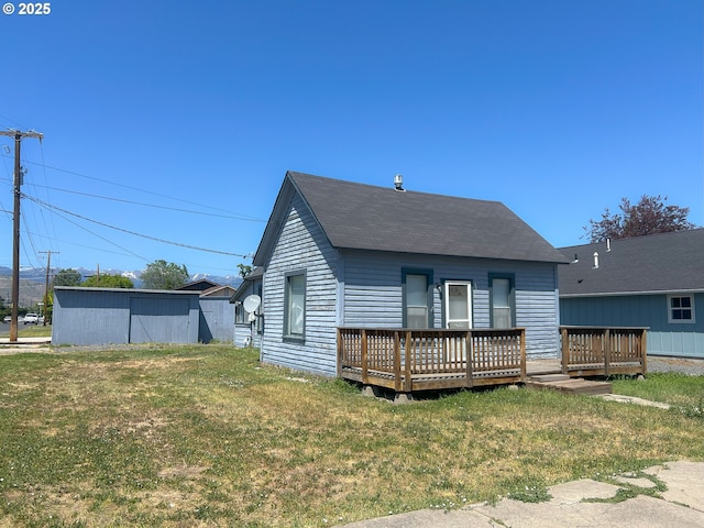2909 College St, Baker City, OR 97814 - rear view of property with a deck, roof with shingles, and a lawn