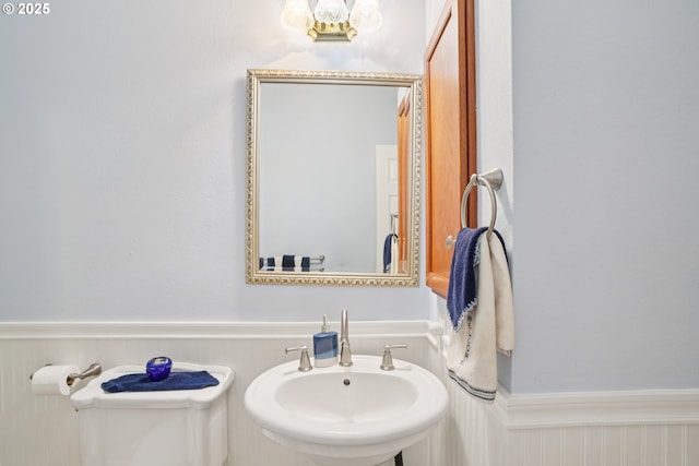 240 NE 5th St, Gresham, OR 97030 - half bathroom with a sink, wainscoting, and toilet
