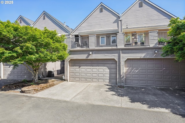 240 NE 5th St, Gresham, OR 97030 - view of front facade with a garage, driveway, a balcony, and central AC