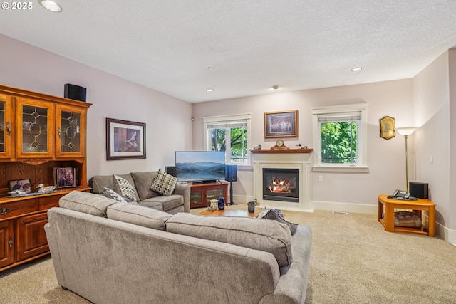 240 NE 5th St, Gresham, OR 97030 - living area featuring light colored carpet, a glass covered fireplace, recessed lighting, and baseboards