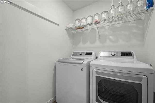 washroom featuring washing machine and clothes dryer