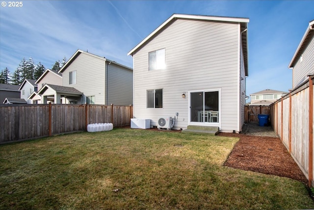 rear view of property with ac unit and a yard