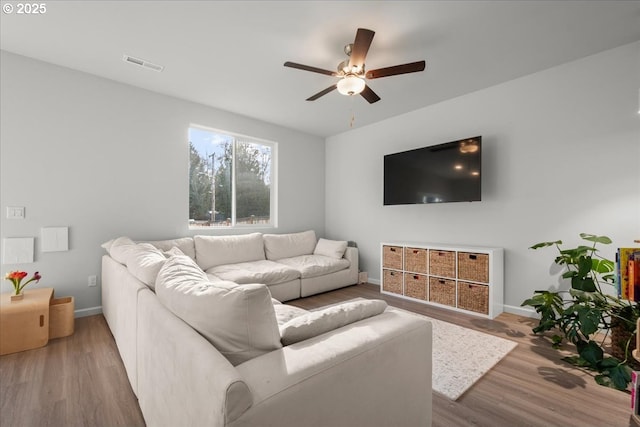 living room with ceiling fan and wood-type flooring