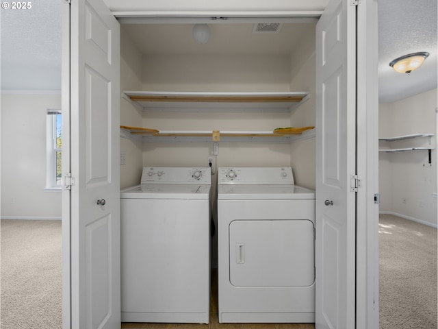 laundry room with carpet flooring, laundry area, separate washer and dryer, baseboards, and visible vents