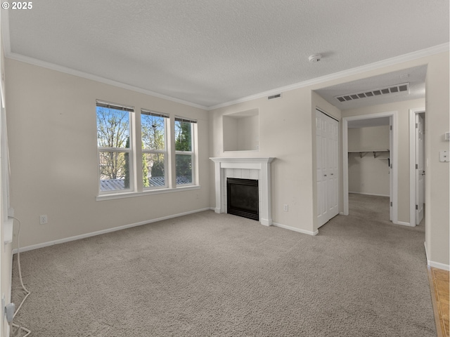 unfurnished living room featuring baseboards, visible vents, a tiled fireplace, and ornamental molding