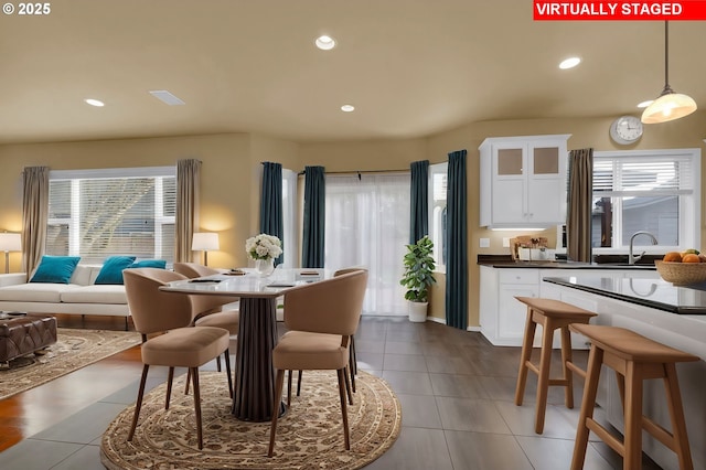 dining space with sink and tile patterned flooring