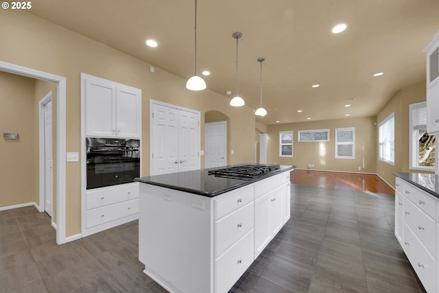 kitchen with black oven, white cabinetry, hanging light fixtures, a center island, and stainless steel gas cooktop