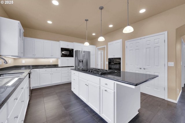 kitchen featuring decorative light fixtures, white cabinetry, sink, a center island, and black appliances