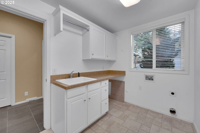 laundry room featuring cabinets, washer hookup, sink, and hookup for an electric dryer