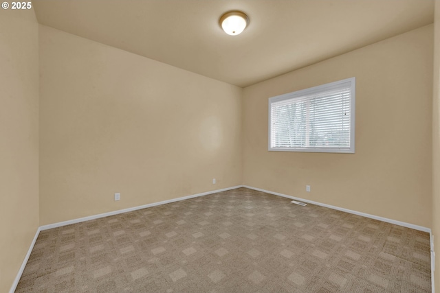 unfurnished room featuring light carpet