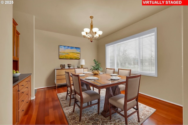 dining space with an inviting chandelier and dark hardwood / wood-style floors