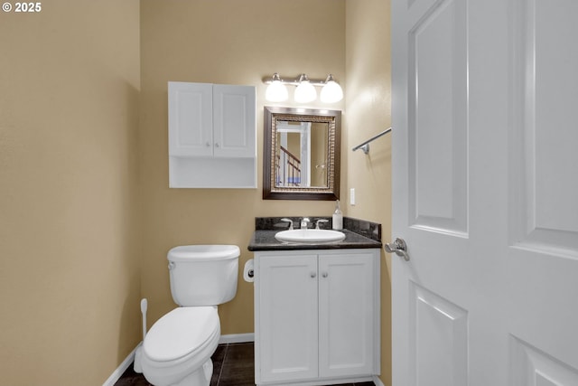 bathroom featuring tile patterned floors, vanity, and toilet