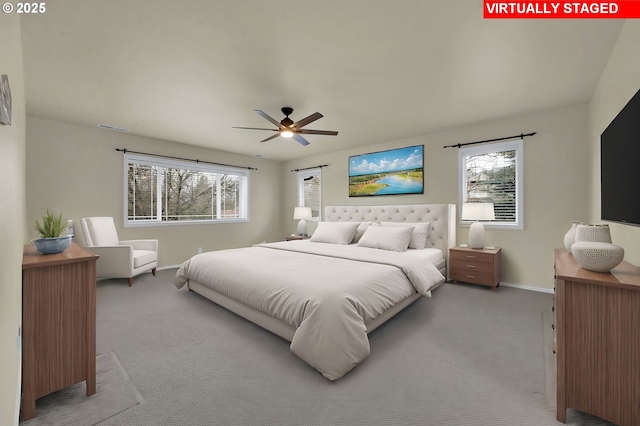 bedroom with multiple windows, light carpet, and ceiling fan