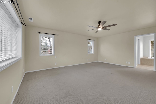 empty room with light colored carpet and ceiling fan