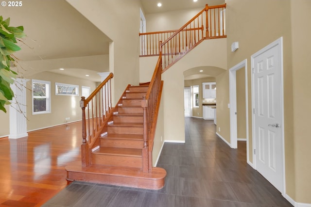 stairs featuring a high ceiling