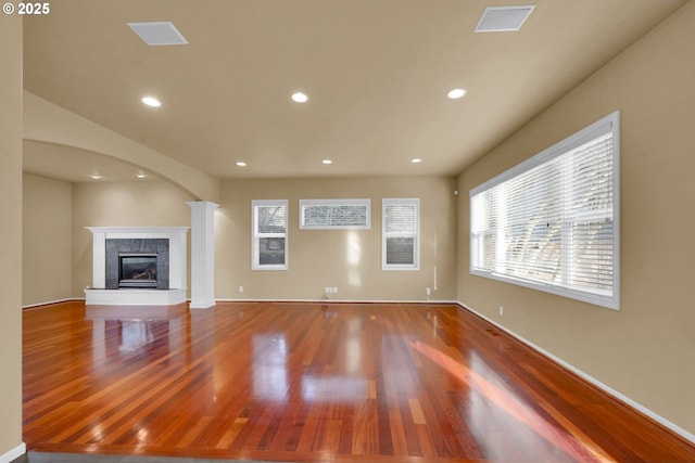 unfurnished living room with hardwood / wood-style flooring and a fireplace