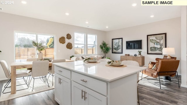 kitchen featuring white cabinetry, dark hardwood / wood-style flooring, and a kitchen island