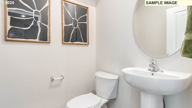 bathroom featuring sink and toilet