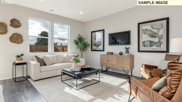 living room featuring vaulted ceiling and light wood-type flooring