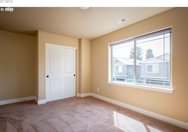 unfurnished bedroom with a closet and carpet flooring