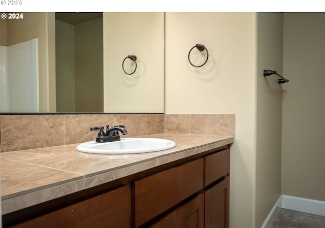 bathroom featuring tile patterned flooring and vanity