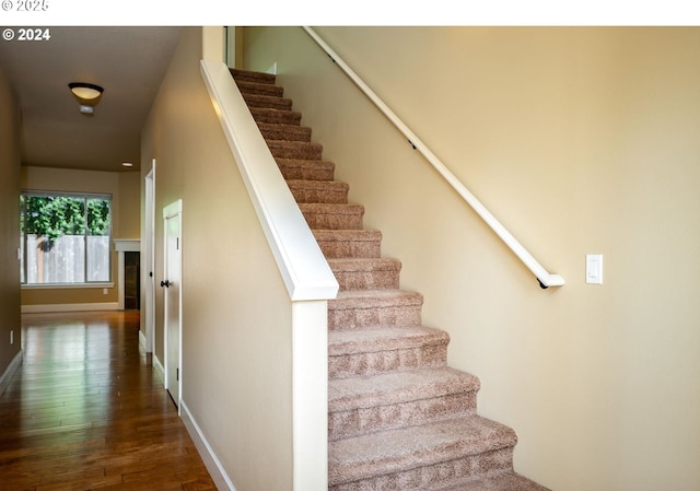 stairway with hardwood / wood-style flooring