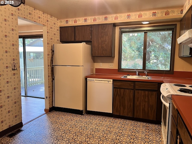 16042 Cornell St, Lake Oswego, OR 97034 - kitchen with white appliances, wallpapered walls, dark brown cabinets, and exhaust hood