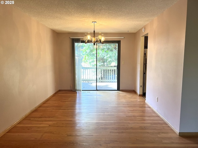 16042 Cornell St, Lake Oswego, OR 97034 - unfurnished dining area featuring wood finished floors, a textured ceiling, and a chandelier