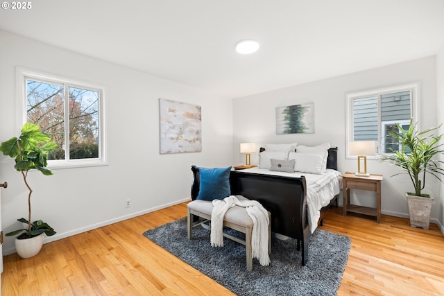 bedroom featuring light wood-style flooring and baseboards