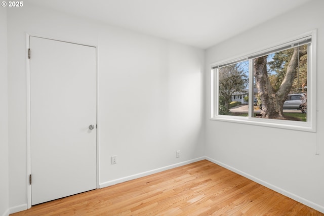 unfurnished bedroom featuring light wood-style floors and baseboards