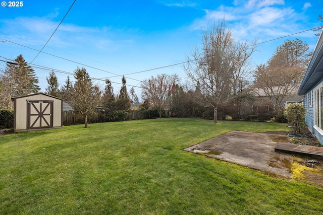 view of yard featuring a storage shed, a fenced backyard, a patio, and an outdoor structure