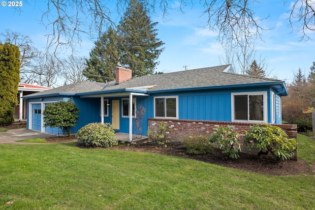 ranch-style house featuring a garage, brick siding, driveway, a front lawn, and a chimney