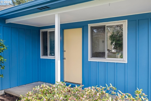 view of exterior entry with board and batten siding