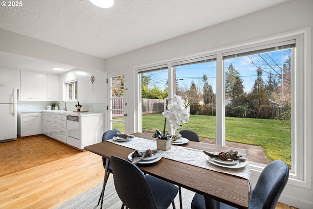 dining area featuring parquet floors, plenty of natural light, and a textured ceiling