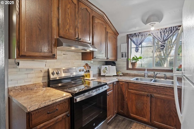 kitchen featuring tasteful backsplash, stainless steel electric range, light countertops, under cabinet range hood, and a sink