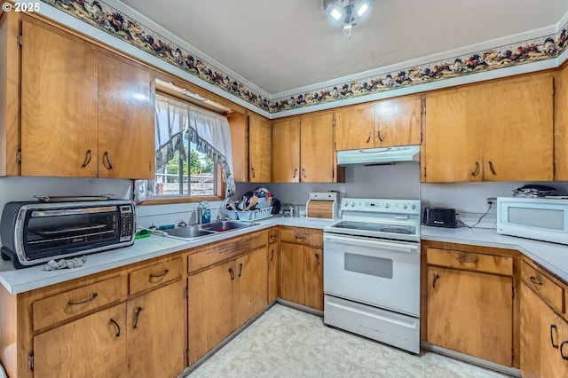 6135 SE Clatsop St, Portland, OR 97206 - kitchen featuring white appliances, under cabinet range hood, light countertops, and brown cabinets