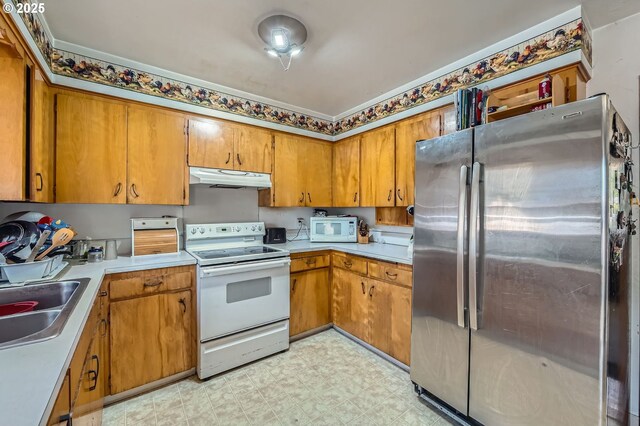 6135 SE Clatsop St, Portland, OR 97206 - kitchen featuring white appliances, under cabinet range hood, light flooring, brown cabinets, and light countertops