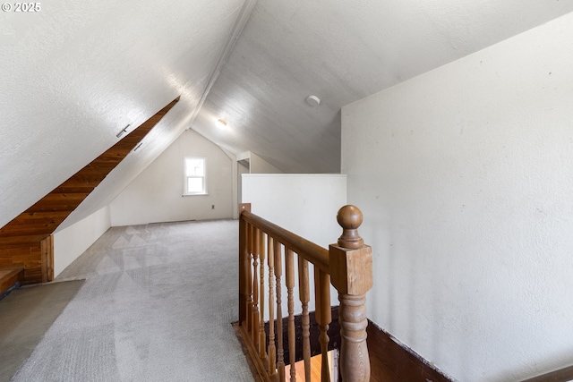 bonus room with lofted ceiling and carpet