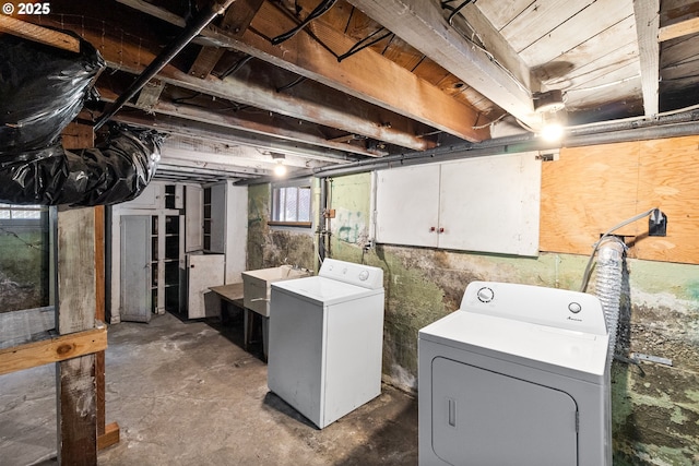 basement featuring washer and dryer and a sink