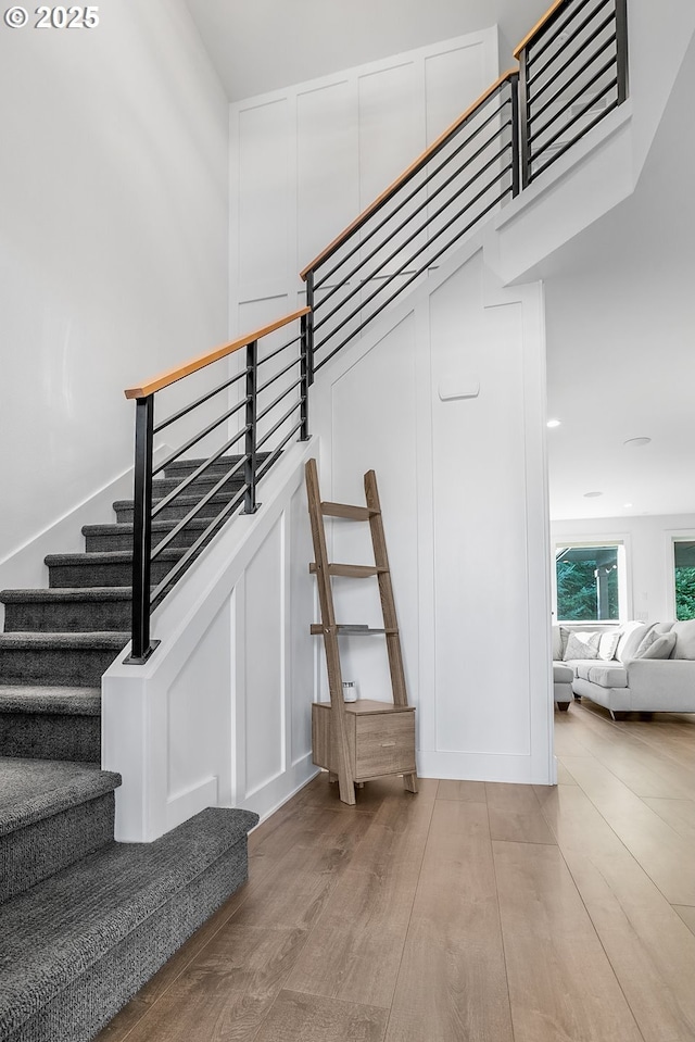 staircase with hardwood / wood-style floors