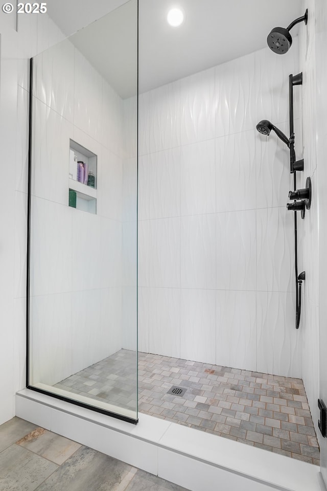 bathroom with a tile shower