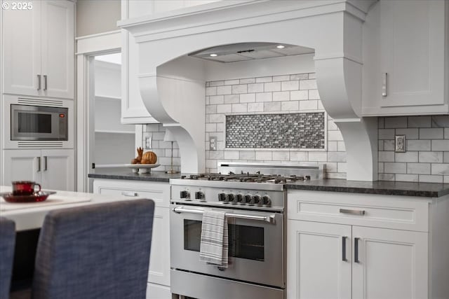 4015 NE 38th Ave, Portland, OR 97212 - kitchen featuring stainless steel appliances, backsplash, and white cabinetry