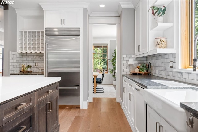 4015 NE 38th Ave, Portland, OR 97212 - kitchen featuring built in fridge, ornamental molding, light wood-style floors, open shelves, and white cabinetry