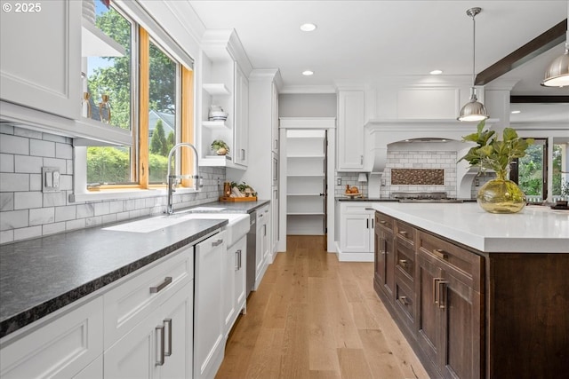 4015 NE 38th Ave, Portland, OR 97212 - kitchen with white cabinetry, dark brown cabinetry, decorative backsplash, light wood finished floors, and recessed lighting