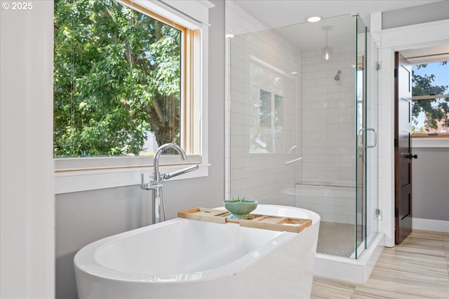 4015 NE 38th Ave, Portland, OR 97212 - full bathroom featuring a shower stall, a freestanding tub, and wood finished floors