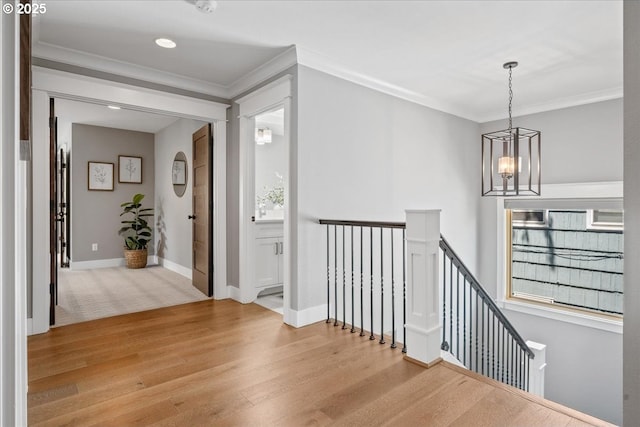 4015 NE 38th Ave, Portland, OR 97212 - hallway with an upstairs landing, a chandelier, light wood-style floors, and ornamental molding