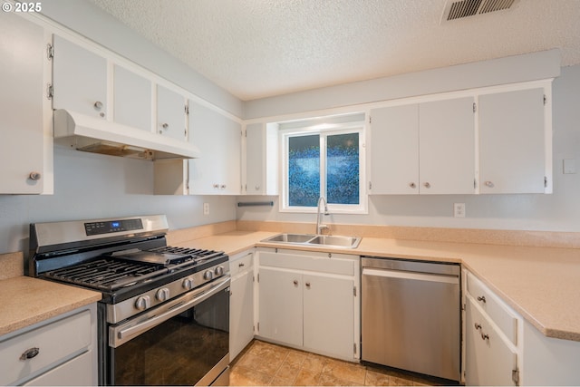 446 44th Ave, Salem, OR 97317 - kitchen featuring appliances with stainless steel finishes, under cabinet range hood, a sink, a textured ceiling, and light countertops