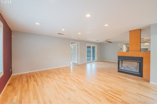 446 44th Ave, Salem, OR 97317 - unfurnished living room with light wood-style floors, recessed lighting, a multi sided fireplace, baseboards, and ceiling fan