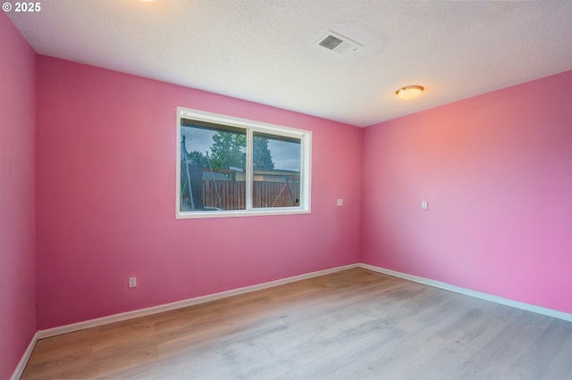 446 44th Ave, Salem, OR 97317 - empty room with wood finished floors, baseboards, and a textured ceiling